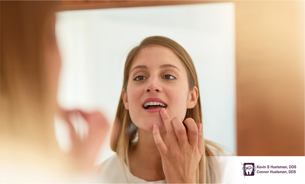 Woman checking her white teeth in the mirror