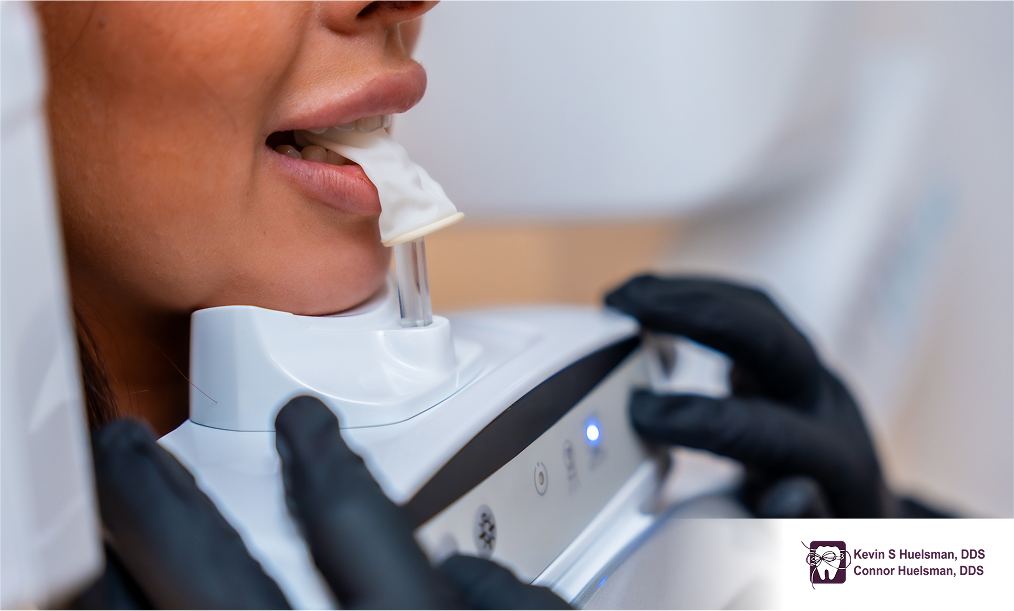 Close-up of teeth whitening procedure using modern technology on woman’s mouth